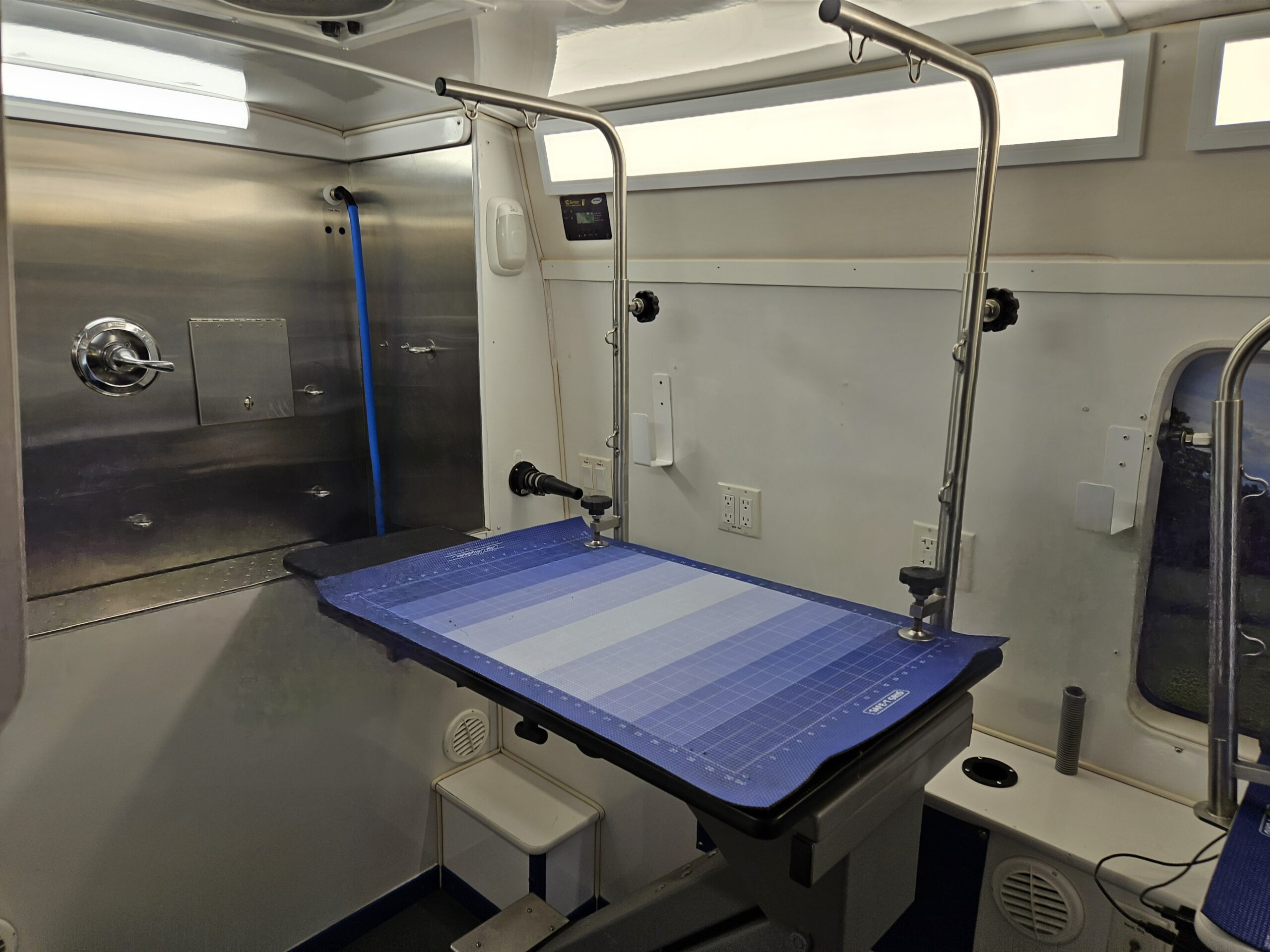Low-entry grooming table and bridge inside the Green Dog mobile salon
