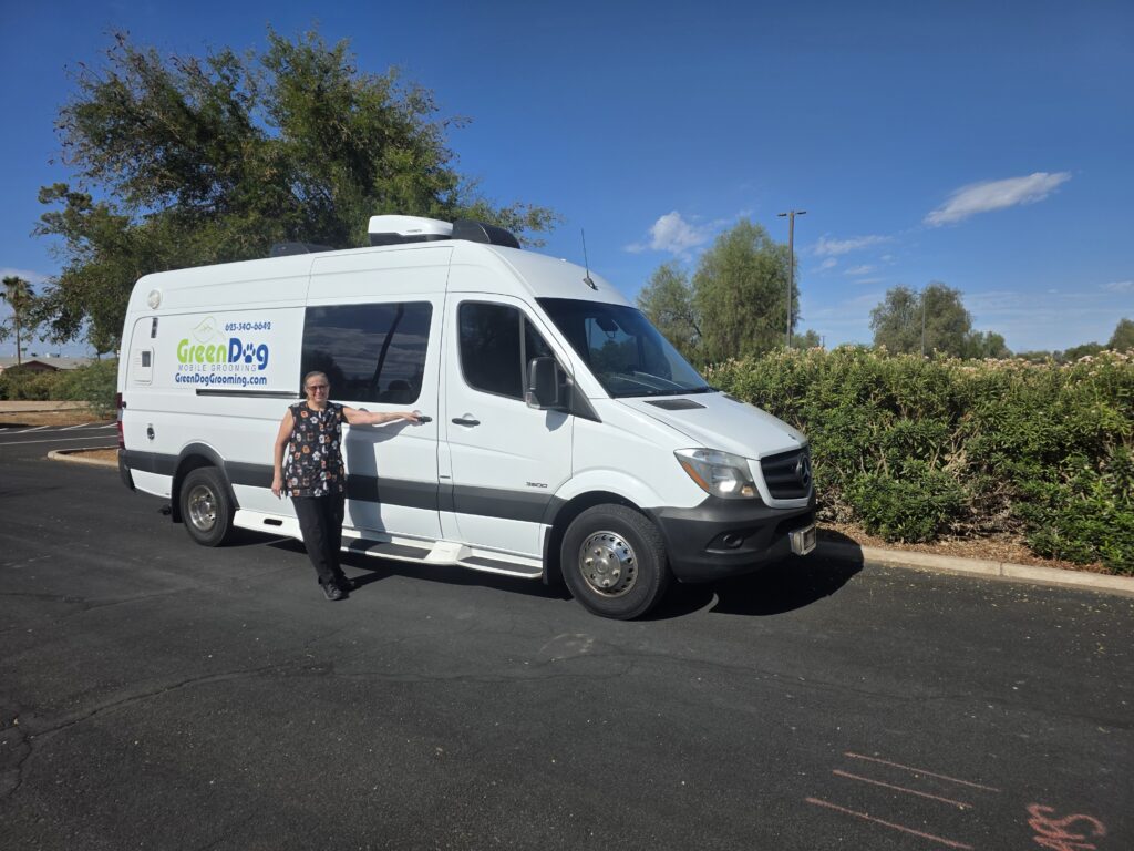 Yvette Ehler standing beside the Green Dog Mobile Grooming van
